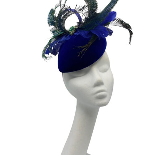 Royal blue velvet teardrop base with an array of peacock feathers and a green jewelled detail to the centre.